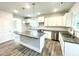 Bright kitchen with white cabinets, gray countertops, stainless steel appliances, and a center island at 217 Lake Edge Dr, Lillington, NC 27546