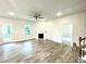 Spacious living room featuring a ceiling fan, fireplace, hardwood floors, and a back patio door at 217 Lake Edge Dr, Lillington, NC 27546