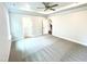 Spacious main bedroom featuring neutral colors, tray ceiling, and carpeted floors at 217 Lake Edge Dr, Lillington, NC 27546