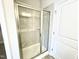 Modern tiled shower with a glass door and chrome trim at 217 Lake Edge Dr, Lillington, NC 27546