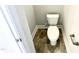 A clean, white toilet in a small area featuring tile floors and white trim at 217 Lake Edge Dr, Lillington, NC 27546