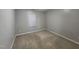 Simple carpeted bedroom with neutral walls and a window at 302 Glenview Ln, Durham, NC 27703