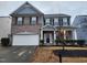 Two-story brick home with attached garage and landscaping at 302 Glenview Ln, Durham, NC 27703
