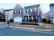 Two-story brick home with gray siding, two-car garage, and landscaping at 302 Glenview Ln, Durham, NC 27703