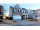 Two-story brick home with gray siding, two-car garage, and landscaping at 302 Glenview Ln, Durham, NC 27703