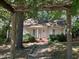 Charming yellow cottage with a front porch and well-maintained landscaping at 322 Mccauley St, Chapel Hill, NC 27516
