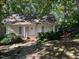 Quaint yellow cottage nestled amongst lush greenery at 322 Mccauley St, Chapel Hill, NC 27516