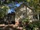 Side view of a yellow cottage showcasing screened porch and brick foundation at 322 Mccauley St, Chapel Hill, NC 27516