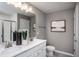 Double vanity bathroom with gray walls and tiled shower at 371 Fosterton Cottage Way, Raleigh, NC 27603