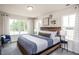 Main bedroom with wood bed frame and window seating at 371 Fosterton Cottage Way, Raleigh, NC 27603