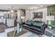 Open living room with green accent wall and view into kitchen at 371 Fosterton Cottage Way, Raleigh, NC 27603