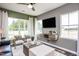 Living room with wood-look floors, large windows and comfortable seating at 371 Fosterton Cottage Way, Raleigh, NC 27603