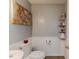 Clean bathroom with white toilet and sink, decorative shelving, and gray walls at 516 Argyll Dr, Sanford, NC 27332