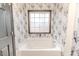 Bathroom with garden tub and floral wallpaper at 516 Argyll Dr, Sanford, NC 27332