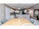Dining area with a light wood table and gray chairs, open to kitchen at 516 Argyll Dr, Sanford, NC 27332
