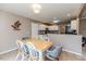 Dining area with light wood table and gray chairs near kitchen at 516 Argyll Dr, Sanford, NC 27332