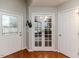 Hardwood floor entryway with white doors and glass french doors at 516 Argyll Dr, Sanford, NC 27332