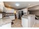 Kitchen features white cabinets, granite countertops and stainless steel appliances at 516 Argyll Dr, Sanford, NC 27332