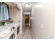 Bright laundry room with washer and dryer, and built-in shelving at 516 Argyll Dr, Sanford, NC 27332