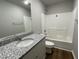Clean bathroom with granite vanity, bathtub, and neutral flooring at 57 Shiloh Dr, Lillington, NC 27546