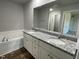 Elegant bathroom with double vanity, granite countertops, and a soaking tub at 57 Shiloh Dr, Lillington, NC 27546