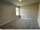 Well-lit bedroom with neutral paint, carpet and a large window at 57 Shiloh Dr, Lillington, NC 27546