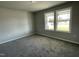 Bright bedroom with neutral wall paint, carpet, and two large windows at 57 Shiloh Dr, Lillington, NC 27546
