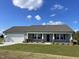 Newly constructed one-story home with gray siding, attached garage, and front porch at 57 Shiloh Dr, Lillington, NC 27546