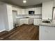 Modern kitchen featuring white cabinets, granite countertops, and stainless steel appliances at 57 Shiloh Dr, Lillington, NC 27546