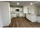 Modern kitchen featuring white cabinets, granite countertops, and stainless steel appliances at 57 Shiloh Dr, Lillington, NC 27546