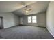 Open living room with neutral wall paint and carpet, and lots of natural light at 57 Shiloh Dr, Lillington, NC 27546