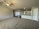 Spacious living room with high ceilings, ceiling fan, and neutral carpeting at 57 Shiloh Dr, Lillington, NC 27546