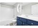 Updated bathroom with white tub and blue vanity at 5734 Corbon Crest Ln, Raleigh, NC 27612