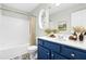 Bathroom with a blue vanity and beige shower curtain at 5734 Corbon Crest Ln, Raleigh, NC 27612