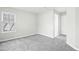 Spacious bedroom with grey carpet and a door to the bathroom at 5734 Corbon Crest Ln, Raleigh, NC 27612
