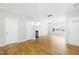 Hardwood floor dining room with chandelier and access to kitchen at 5734 Corbon Crest Ln, Raleigh, NC 27612