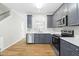 Modern kitchen with gray cabinets, quartz countertops, and stainless steel appliances at 5734 Corbon Crest Ln, Raleigh, NC 27612
