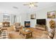 Bright living room with fireplace, hardwood floors, and stylish furniture at 5734 Corbon Crest Ln, Raleigh, NC 27612