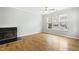 Spacious living room featuring hardwood floors, fireplace, and large windows at 5734 Corbon Crest Ln, Raleigh, NC 27612