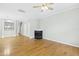 Living room featuring hardwood floors, a fireplace, and ceiling fan at 5734 Corbon Crest Ln, Raleigh, NC 27612