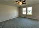 Bright bedroom with carpet flooring and two large windows at 59 Holly Grove Ln, Lillington, NC 27546