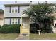 Gray two-story townhome with yellow steps and landscaping at 6548 English Oaks Dr, Raleigh, NC 27615