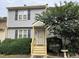 Gray two-story townhome with yellow steps and landscaping at 6548 English Oaks Dr, Raleigh, NC 27615