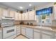 Bright kitchen features white appliances and ample cabinet space at 6548 English Oaks Dr, Raleigh, NC 27615