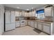 White appliances and cabinets, tile floor in this galley kitchen at 6548 English Oaks Dr, Raleigh, NC 27615