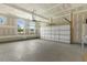 Unfinished two-car garage with concrete floor and ample overhead storage at 72 Demascus Way, Four Oaks, NC 27524