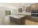 Modern kitchen with ample cabinetry, quartz countertops, and a breakfast bar at 72 Demascus Way, Four Oaks, NC 27524