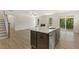 Open concept kitchen with large island, stainless steel appliances, and hardwood floors at 72 Demascus Way, Four Oaks, NC 27524