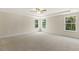 Large main bedroom with plush carpeting, ceiling fan, and multiple windows at 72 Demascus Way, Four Oaks, NC 27524