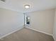Well-lit bedroom with carpet and window at 917 Palm Ct, Mebane, NC 27302